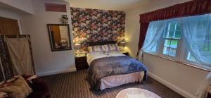 a bedroom with a bed and a window at Island House in Lanercost