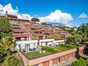 an apartment building with a green roof at Apartment Lake & Pool by Interhome in Leggiuno