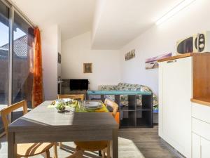 a kitchen and dining room with a table and chairs at Apartment Lake & Pool by Interhome in Leggiuno