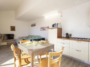 a kitchen and dining room with a table and chairs at Apartment Lake & Pool by Interhome in Leggiuno +25 photos