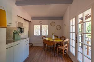 a kitchen with a table and a dining room at villa Léonfine in Le Cannet-des-Maures