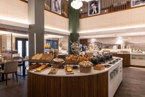 a bakery with a counter with different types of food at Holiday Inn Naples by IHG in Naples