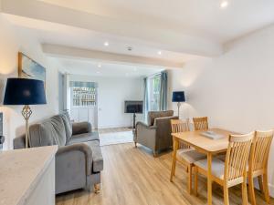 a living room with a couch and a table at Cartmel Cottage in Lindale