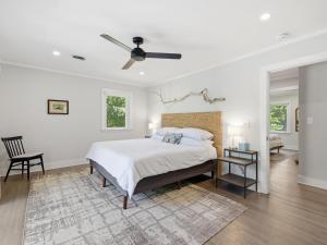 a white bedroom with a bed and a ceiling fan at Dragonfly Cove in Bozman +54 photos