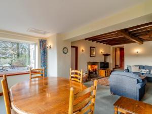 a dining room with a table and a living room at Griff Head Cottage in Carlton