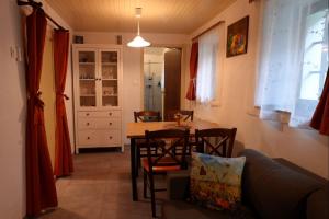 a kitchen and dining room with a table and chairs at Hiša Varleh in Mengeš