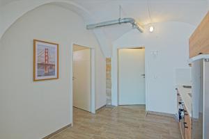 a room with a hallway with white walls and a door at Denkmal-Wohnung in Bamberg in Bamberg +50 photos