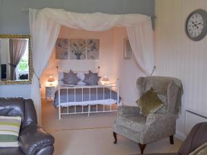 a bedroom with a bed and a chair and a couch at Gibson Apt- Cv11 in Liskeard