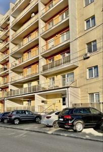 a group of cars parked in front of a building at Ama Residence 1 in Deva