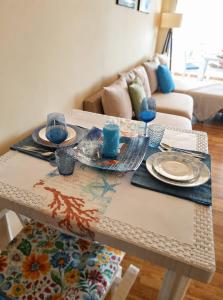 a table with plates on it in a living room at DeJon Apartment in Gjilek