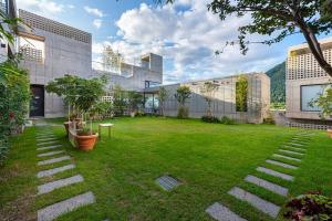 a yard of a building with a grassy yard at Chuncheon Onda Poolvilla in Chuncheon