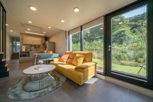 a living room with a yellow couch and a table at Chuncheon Onda Poolvilla in Chuncheon +55 photos
