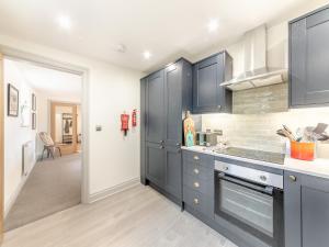 a kitchen with blue cabinets and a counter top at Number 29 in Alnwick