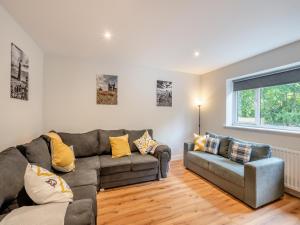 a living room with a couch and a chair at The Caddy's Lodge - Uk47762 in Bamburgh
