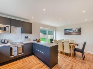 a kitchen and dining room with a table and chairs at The Caddy's Lodge - Uk47762 in Bamburgh