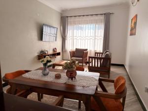 a living room with a table and chairs and a room at Express Living & Wellness in Jinja +40 photos