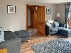 a living room with a couch and a chair at The Cottage in Whiting Bay