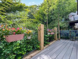 a wooden deck with potted plants and flowers at Fronisaf - Uk49775 in Llanfair Talhaiarn