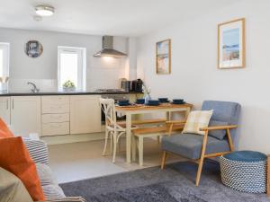 a kitchen and dining room with a table and chairs at Strandside Townhouse in Bude