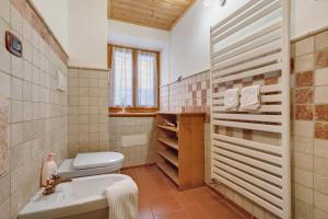 a bathroom with a toilet and a sink at Casa Sole in Ceniga +39 photos
