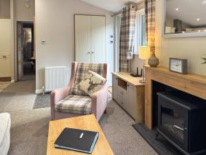 a living room with a chair and a fireplace at Portland in Poole