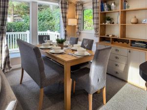 a dining room with a wooden table and chairs at Portland in Poole +5 photos