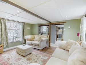 a living room with a couch and a table at Duck Island Cottage in Ringwood