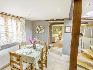 a kitchen and dining room with a table and chairs at Duck Island Cottage in Ringwood