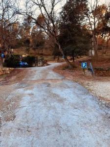 a gravel road with a car parked on the side at Masllandrich Hostal Rural in Porqueres