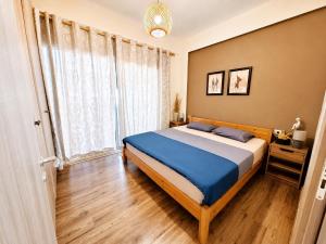 a bedroom with a bed and a large window at DeJon Apartment in Gjilek