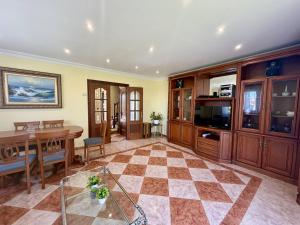 a living room with a table and a dining room at Apartamento Albamar 32802 in Pedreña