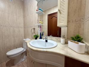 a bathroom with a sink and a toilet at Apartamento Albamar 32802 in Pedreña +20 photos