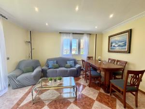 a living room with a couch and a table at Apartamento Albamar 32802 in Pedreña