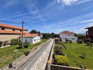 a street in a village with houses and grass at Apartamento Albamar 32802 in Pedreña