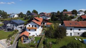 a group of houses on a hill with grass at Ferienwohnung Christina in Mauth