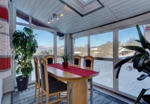 a dining room with a table and chairs in front of a window at Ferienwohnung Christina in Mauth
