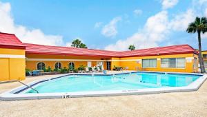 a swimming pool in front of a building at Magnuson Hotel Jacksonville Downtown in Jacksonville