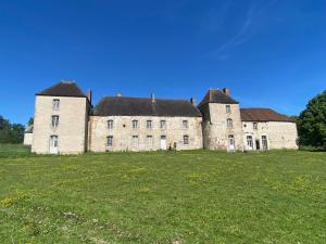 an old stone building in a field of grass at Chateau de Grandsagne in Bonnat