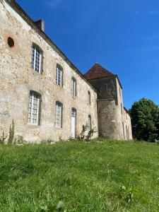 an old stone building on a field of grass at Chateau de Grandsagne in Bonnat +29 photos