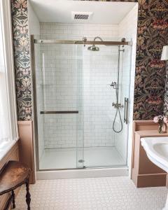 a shower with a glass door in a bathroom at Historic Knox Hotel in Princeton