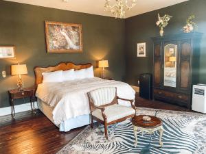 a bedroom with a bed and a chair and a rug at Historic Knox Hotel in Princeton +7 photos