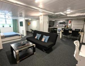 a living room with a couch and a table at The Alpine Studio Hideout in Schwanden