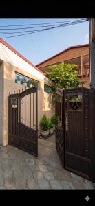 a pair of gates in front of a house at Guest House Kobuleti 516 in Kobuleti