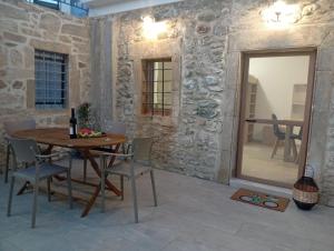 a dining room with a table and chairs and a mirror at Kimourioti Green House in Sitia +18 photos