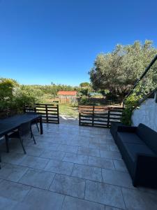 a patio with two benches and a fence at F2 Ismaël in Solliès-Pont