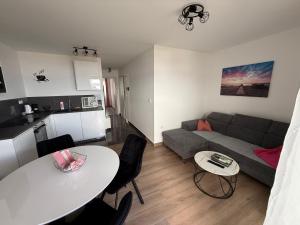 a living room with a couch and a table at AppMishadze in Crikvenica