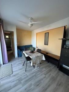 a living room with a table and a couch at F2 Ismaël in Solliès-Pont +1 photo