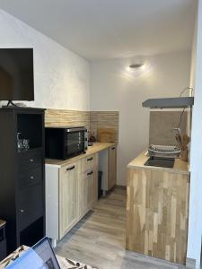 a kitchen with a microwave and a counter top at F2 Ismaël in Solliès-Pont