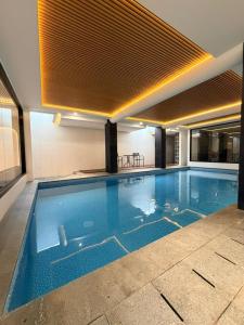 a large swimming pool in a building at Grand WK Hotel in Yogyakarta