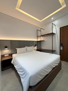 a bedroom with a large white bed in a room at Grand WK Hotel in Yogyakarta